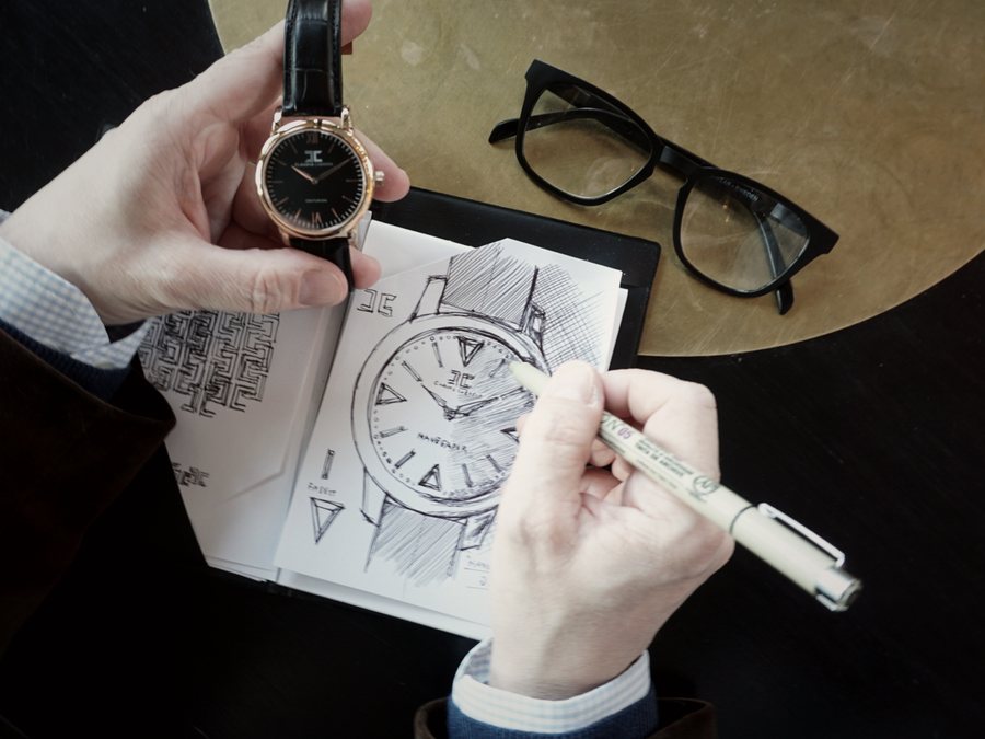 Claudio Cabrera sketching the watch design by hand while holding the finished watch